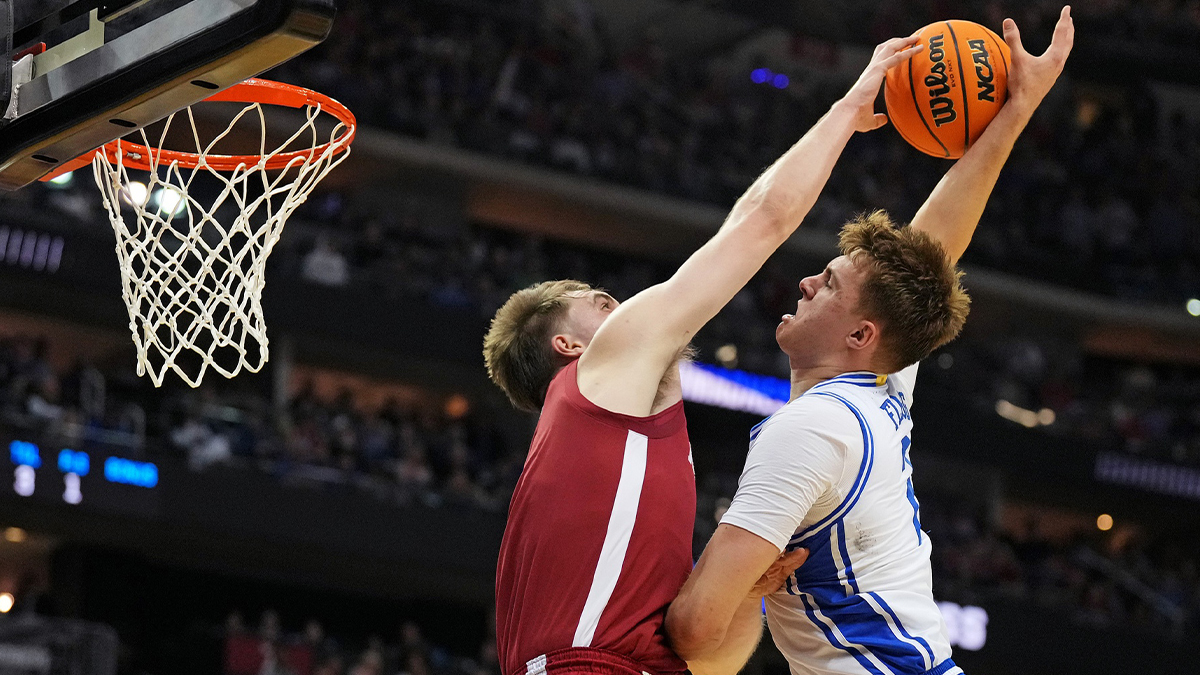 Alabama Crimson Tide forward Grant Nelson (4) blocks the shot of Duke Blue Devils forward Cooper Flagg (2) during the first half in the East Regional final of the 2025 NCAA tournament at Prudential Center.