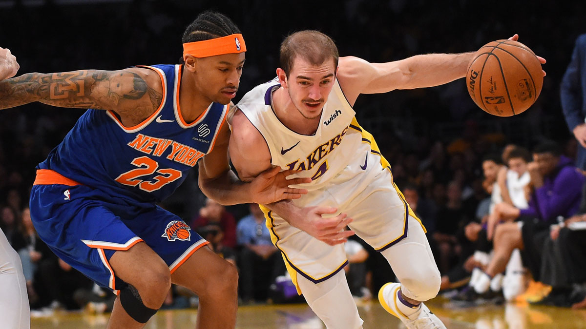 New York Knicks guard Trey Burke (23) defends Los Angeles Lakers guard Alex Caruso (4) as he drives to the basket in the second half at Staples Center.