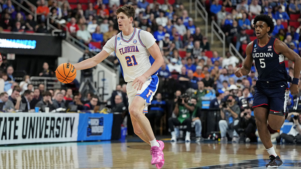 Florida Gators forward Alex Condon (21) drives to the basket as Connecticut Huskies center Tarris Reed Jr. (5) defends during the second half in the second round of the NCAA Tournament at Lenovo Center.