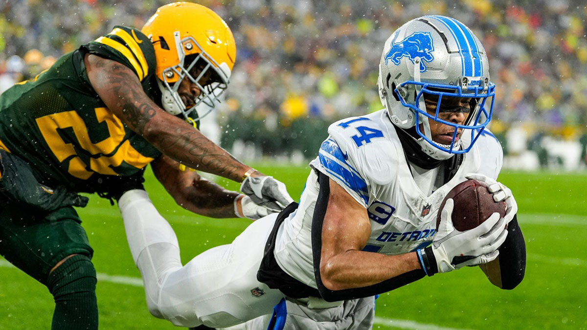 Detroit Lions wide receiver Amon-Ra St. Brown (14) makes a catch for a touchdown against Green Bay Packers cornerback Keisean Nixon (25) during the first half at Lambeau Field in Green Bay, Wis. on Sunday, Nov. 3, 2024.