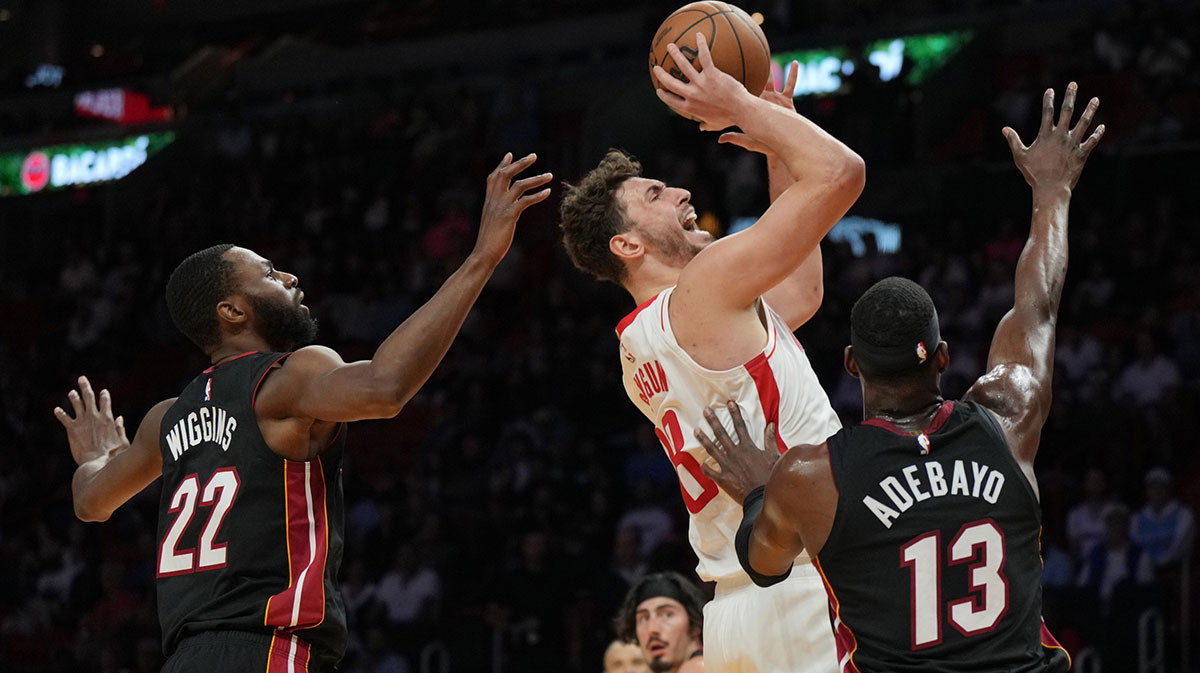 Houston Rockets center Alperen Sengun (28) takes a shot over Miami Heat forward Andrew Wiggins (22) and center Bam Adebayo (13) in the first half at Kaseya Center.