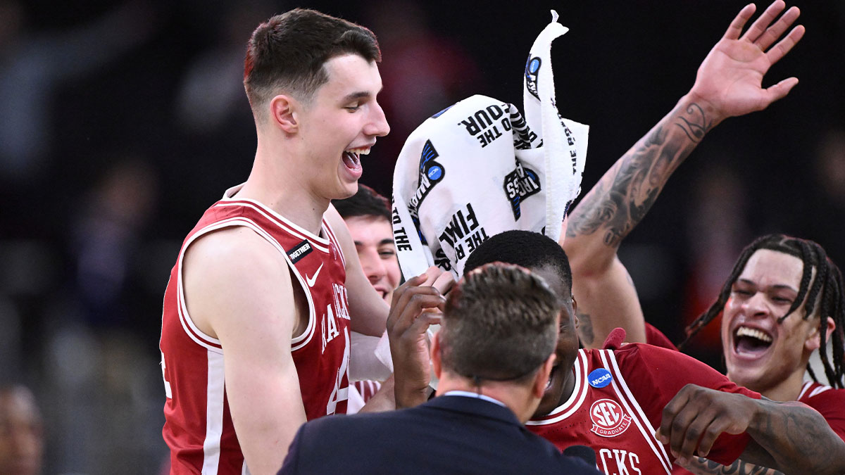 Arkansas Razorbacks forward Zvonimir Ivisic (44) and teammates celebrate after defeating the St. John's Red Storms in a second round men’s NCAA Tournament game at Amica Mutual Pavilion.