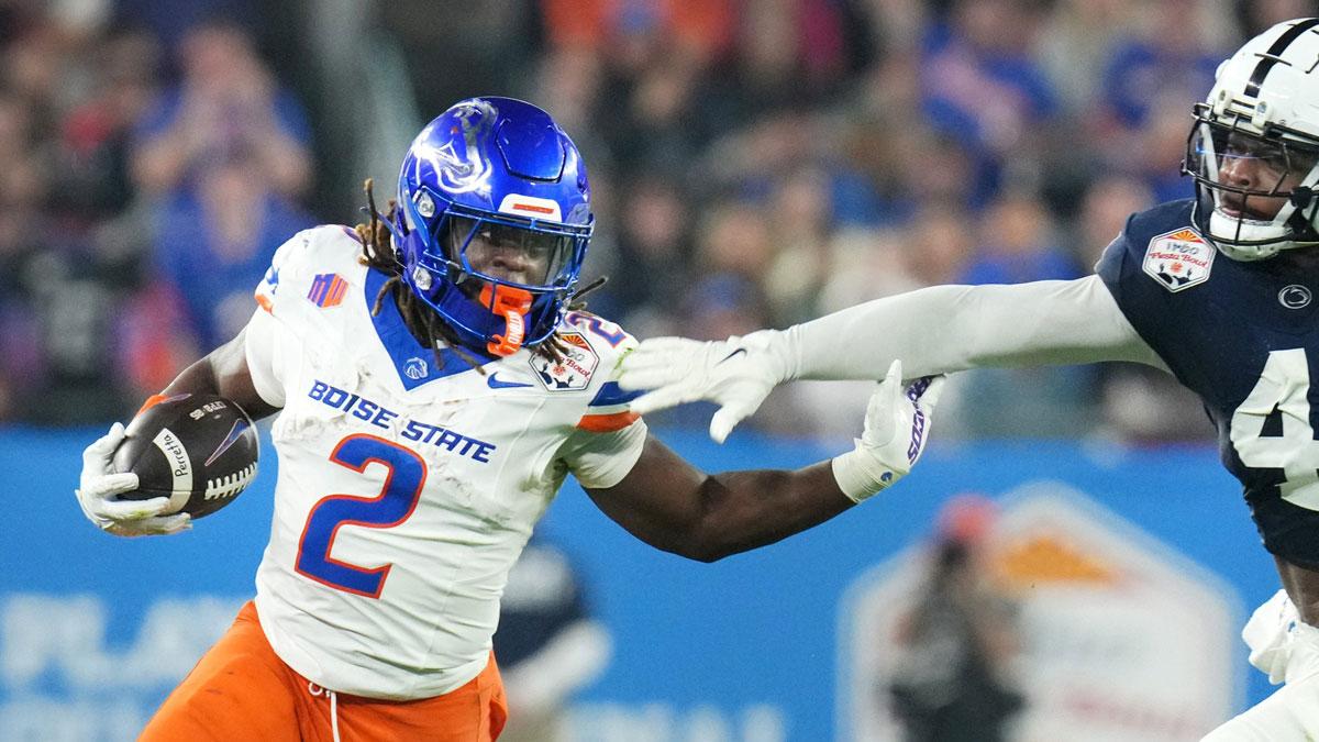 Boise State Broncos running back Ashton Jeanty (2) runs past Penn State Nittany Lions linebacker Kobe King (41) during their Vrbo Fiesta Bowl matchup at State Farm Stadium on Dec. 31, 2024.