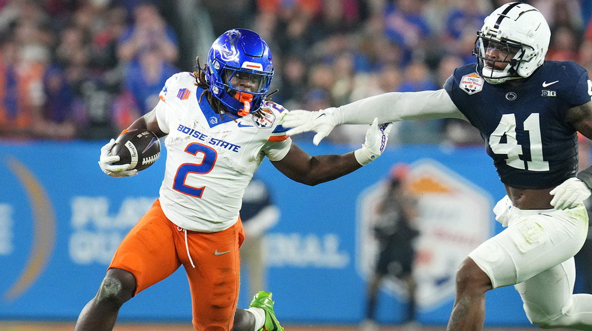 Boise State Broncos running back Ashton Jeanty (2) runs past Penn State Nittany Lions linebacker Kobe King (41) during their Vrbo Fiesta Bowl matchup at State Farm Stadium on Dec. 31, 2024.