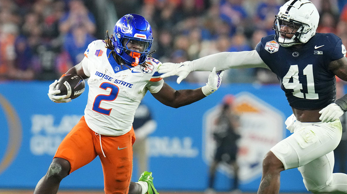 Boise State Broncos running back Ashton Jeanty (2) runs past Penn State Nittany Lions linebacker Kobe King (41) during their Vrbo Fiesta Bowl matchup at State Farm Stadium on Dec. 31, 2024.