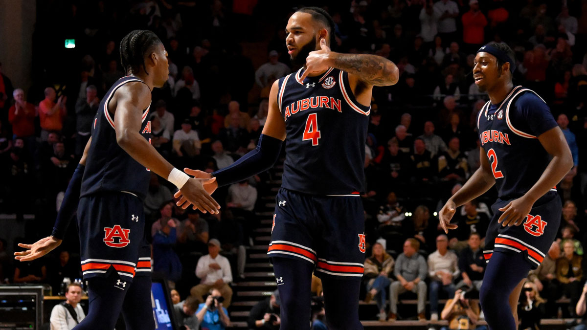 Auburn Tigers forward Johni Broome (4) reacts after a made three-point basket by guard Denver Jones (2) against the Vanderbilt Commodores during the first half at Memorial Gymnasium. March Madness