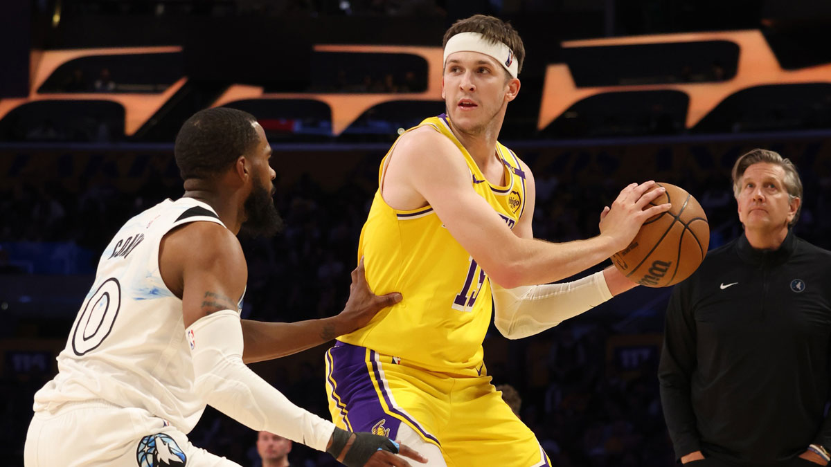 Los Angeles Lakers guard Austin Reaves (15) looks to pass against Minnesota Timberwolves guard Mike Conley (10) during the second quarter at Crypto.com Arena.