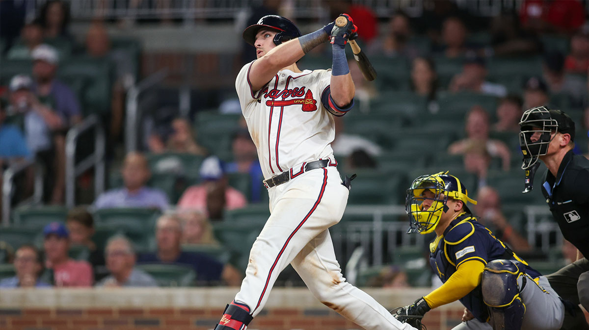 Aug 7, 2024; Atlanta, Georgia, USA; Atlanta Braves third baseman Austin Riley (27) hits a two-run home run against the Milwaukee Brewers in the fifth inning at Truist Park. 