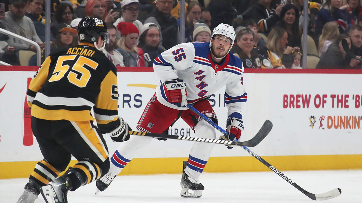 New York Rangers defenseman Ryan Lindgren (right) moves the puck as Pittsburgh Penguins center Noel Acciari (55) defends during the third period at PPG Paints Arena. 