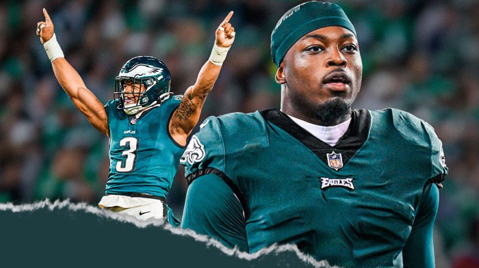 Azeez Ojulari wearing a number 13 Eagles uniform next to Nolan Smith on the Eagles field.