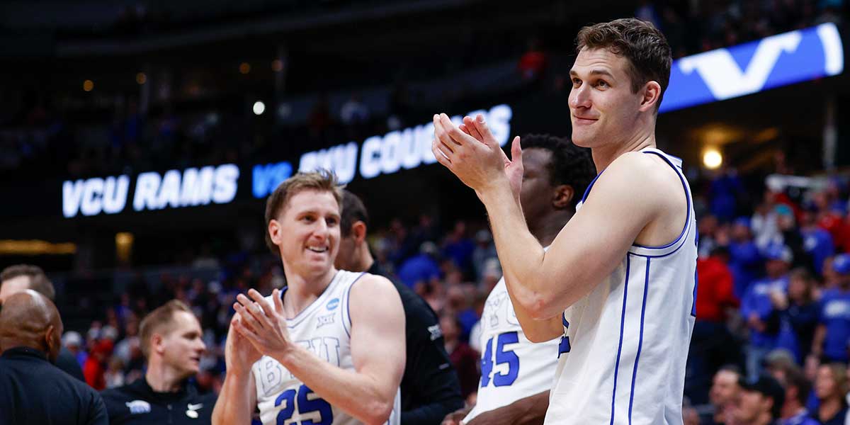 Brigham Young Cougars guard Dawson Baker (25) and guard Trevin Knell (21) celebrate on the bench during the second half against the VCU Rams in the first round of the NCAA Tournament at Ball Arena.