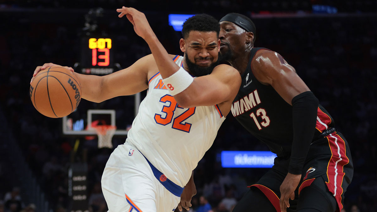 New York Knicks Center Karl-Anthony Cities (32) drive to the basket against Miami of the Heat Center Bam Adebaiio (13) during the first quarter in the center of Kaseya.