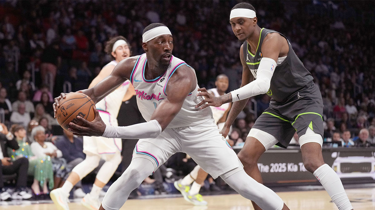 Miami Heat center Bam Adebayo (13) secures a rebound as Minnesota Timberwolves forward Jaden McDaniels (3) closes in during the second half at Kaseya Center. 