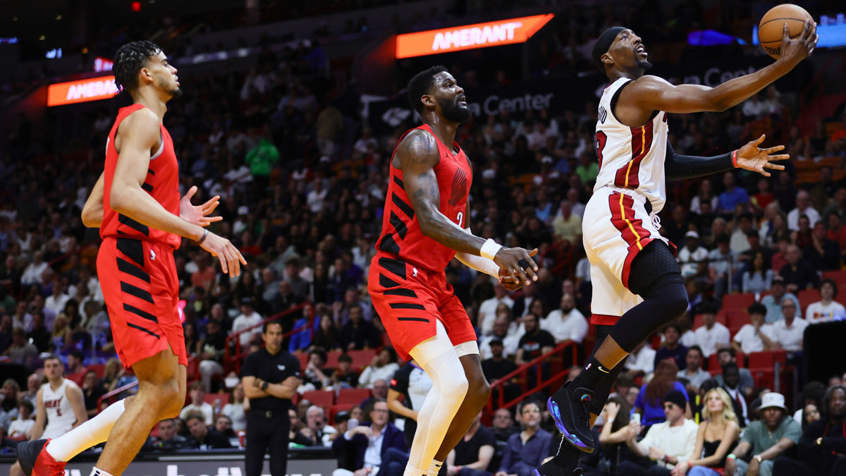 Miami Heating Center Bam Adebaiio (13) Drive in the basket of last Portland Travel Blazers Center Deandra Aton (2) during the second quarter in the Kaseya Center. 