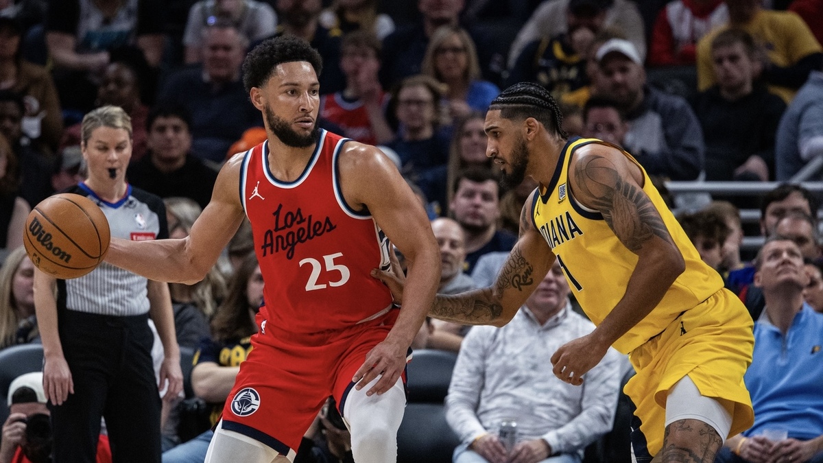 LA Clippers guard Ben Simmons (25) dribbles the ball while Indiana Pacers forward Obi Toppin (1) defends in the second half at Gainbridge Fieldhouse.