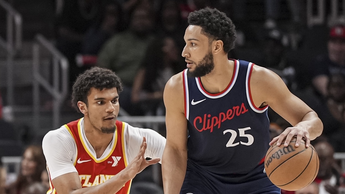 LA Clippers guard Ben Simmons (25) dribbles defended by Atlanta Hawks forward Dominick Barlow (0) during the first half at State Farm Arena.