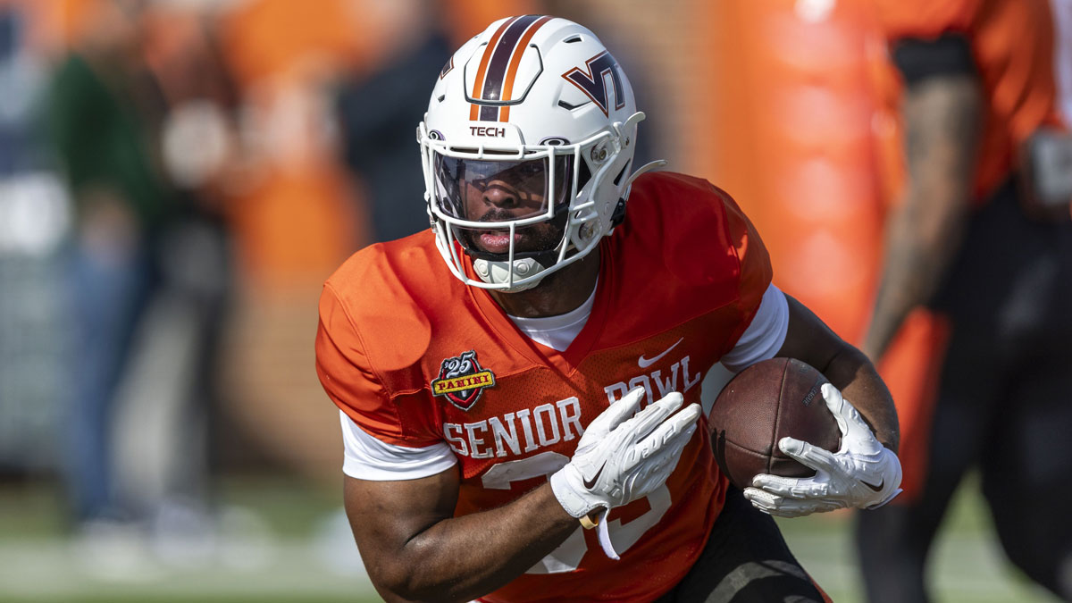 National team running back Bhayshul Tuten of Virginia Tech (33) runs the ball during Senior Bowl practice for the National team at Hancock Whitney Stadium