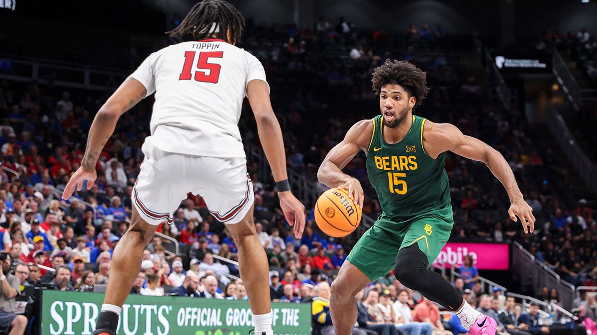 Baylor Bears forward Norchad Omier (15) dribbles the ball as Texas Tech Red Raiders forward JT Toppin (15) defends during the second half at T-Mobile Center.