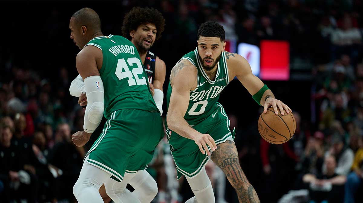 The Boston Celtics striker Jayson Tatum (0) dribbles around a set screen by the Al Horford Center (42) during the second half against the Portland Trail Blazers Matisse Thybulle (4) at Moda Center.