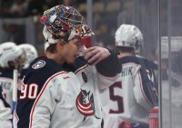Columbus Blue Jackets goaltender Elvis Merzlikins (90) takes a drink of a soft drink during a time-out against the Pittsburgh Penguins in the third period at PPG Paints Arena.