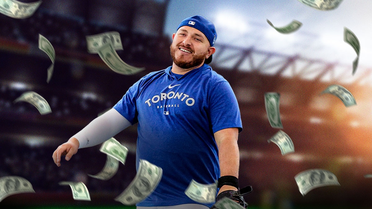 Blue Jays' Alejandro Kirk with money falling down in the background