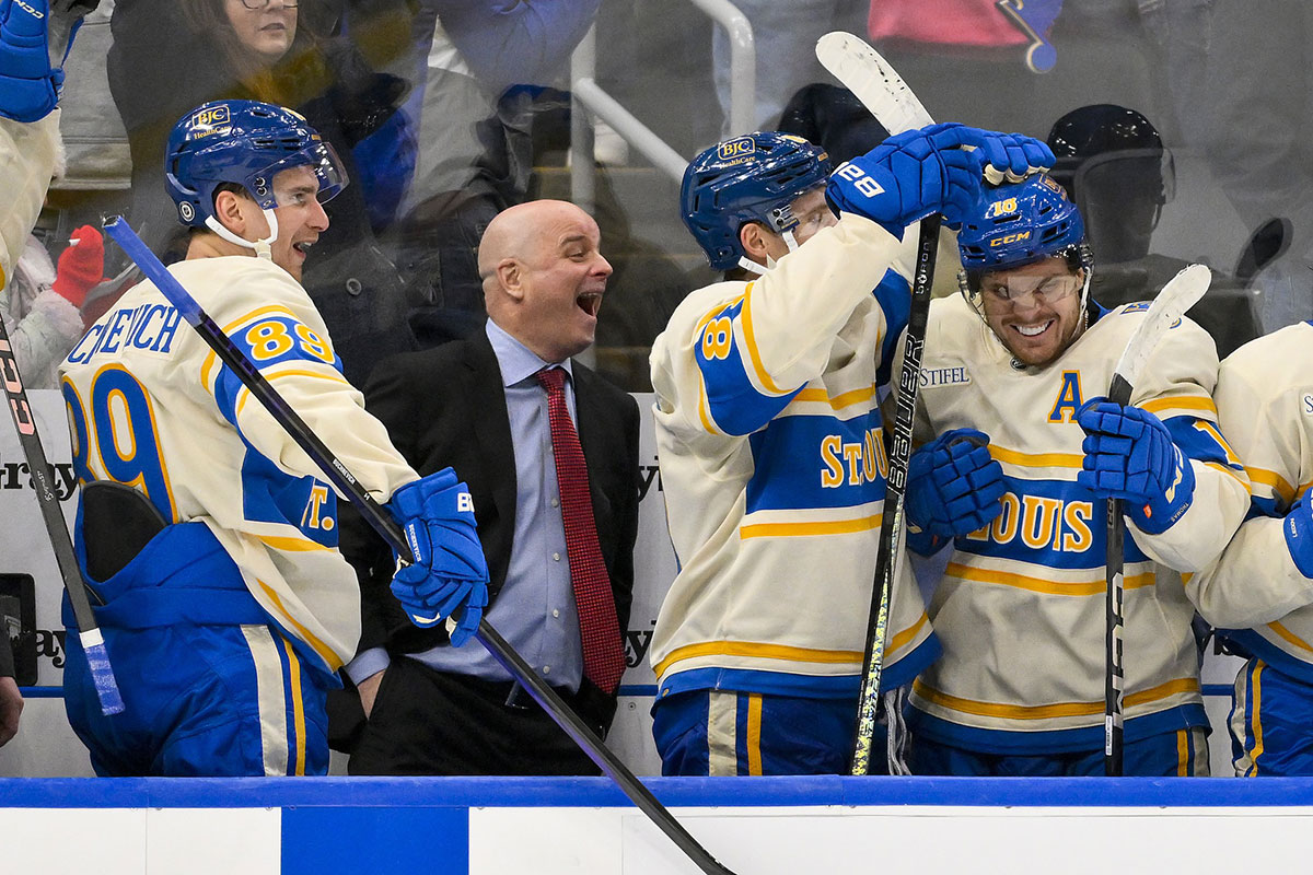 St. Louis Blues left wing Pavel Buchnevich (89) head coach Jim Montgomery center Dylan Holloway (81) and center Robert Thomas (18) react after center Radek Faksa (not pictured) scored the game winning goal in the 10th round of shootouts against the Chicago Blackhawks at Enterprise Center.