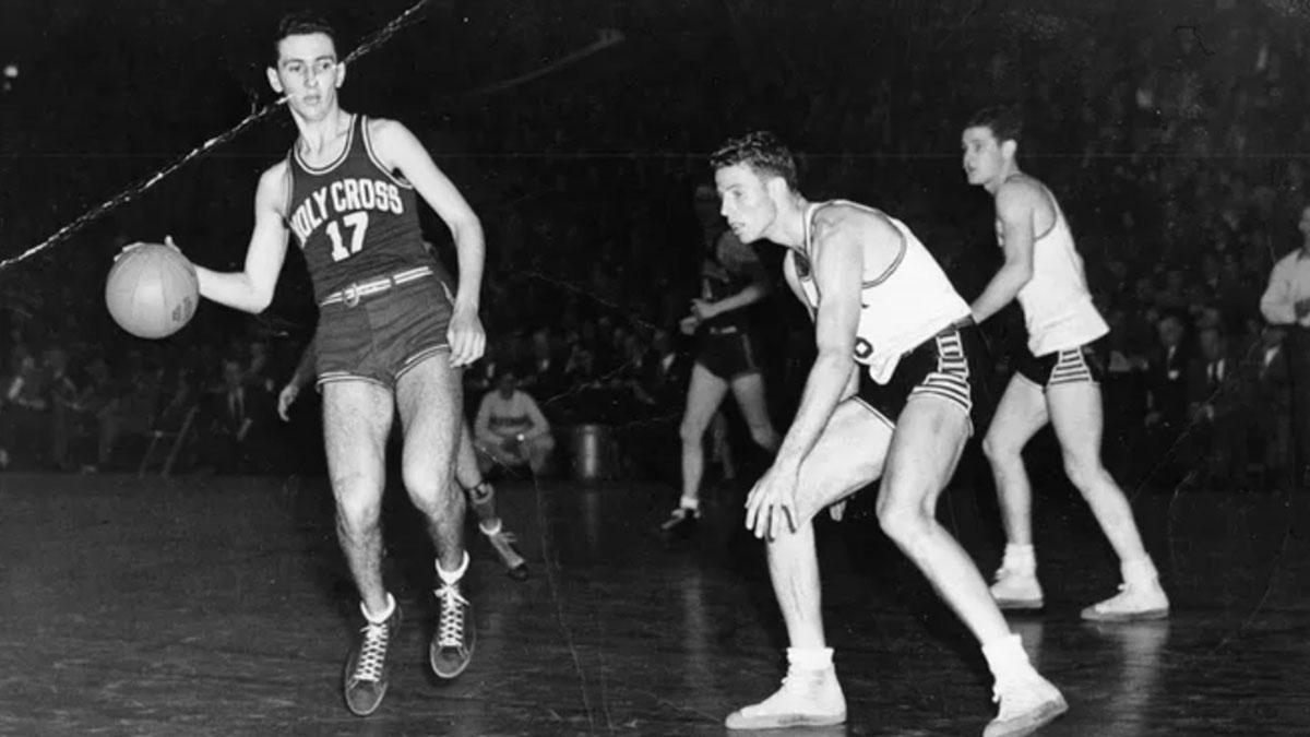 Bob Cousy takes the ball upcourt for Holy Cross.