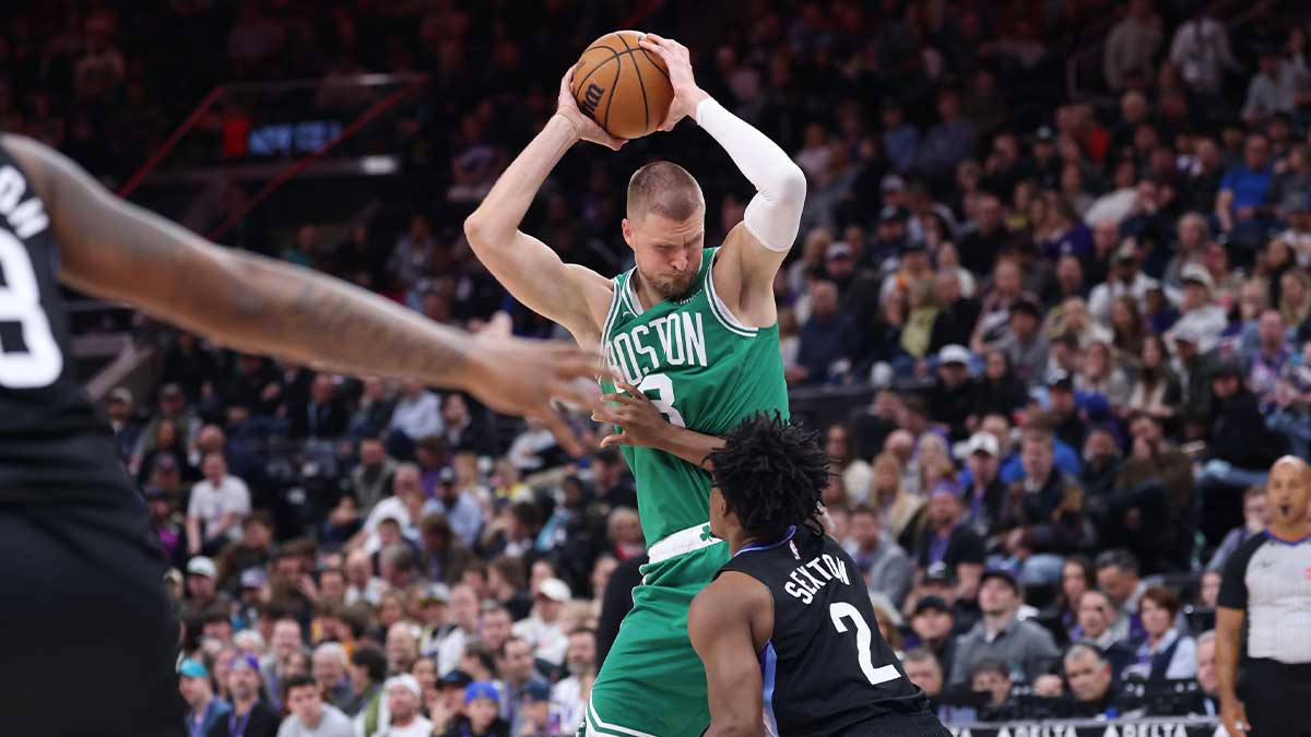 Boston Celtics center Kristaps Porzingis (8) posts up against Utah Jazz guard Collin Sexton (2) during the first half at Delta Center.