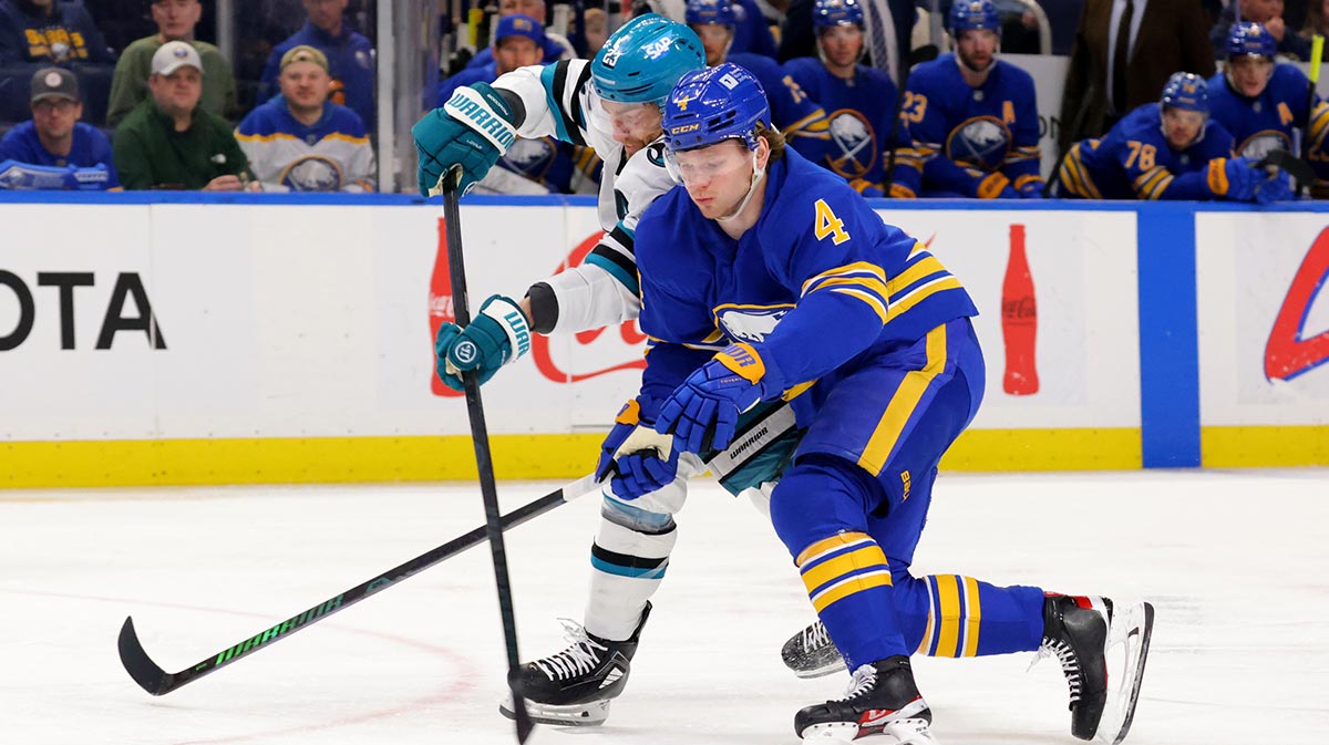 San Jose Sharks right wing Barclay Goodrow (23) tries to take a shot on goal as Buffalo Sabres defenseman Bowen Byram (4) defends during the first period at KeyBank Center.