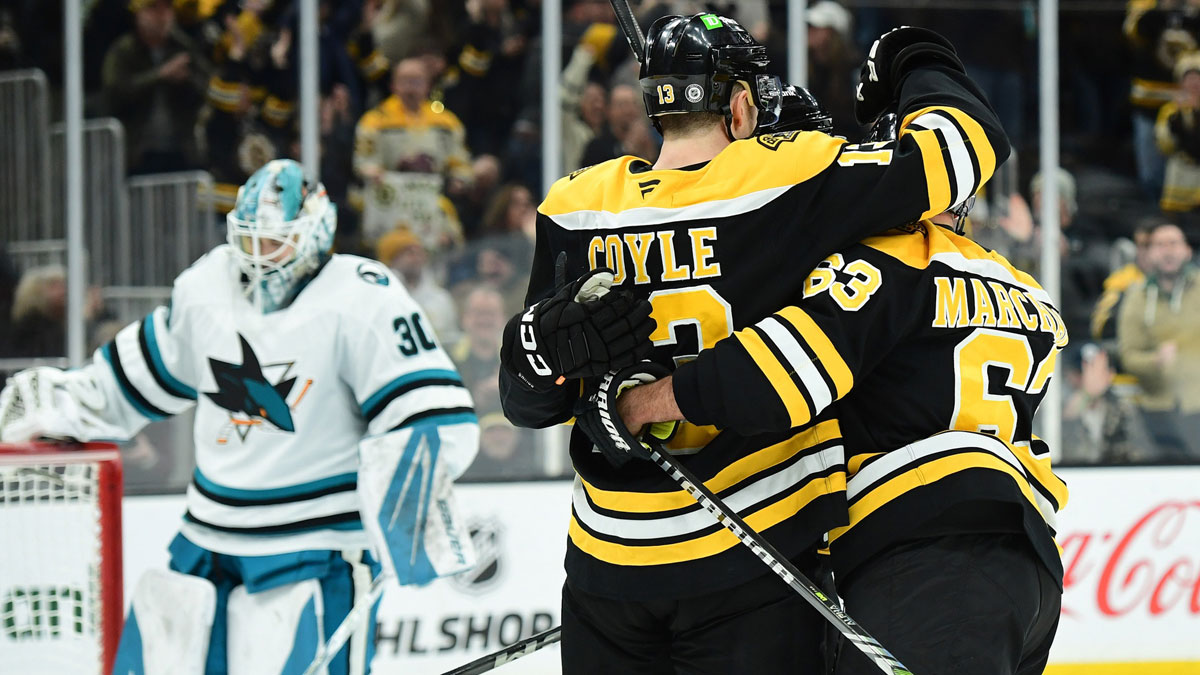 Boston Bruins center Charlie Coyle (13) is congratulated by left wing Brad Marchand (63) after scoring a goal during the third period against the San Jose Sharks at TD Garden.