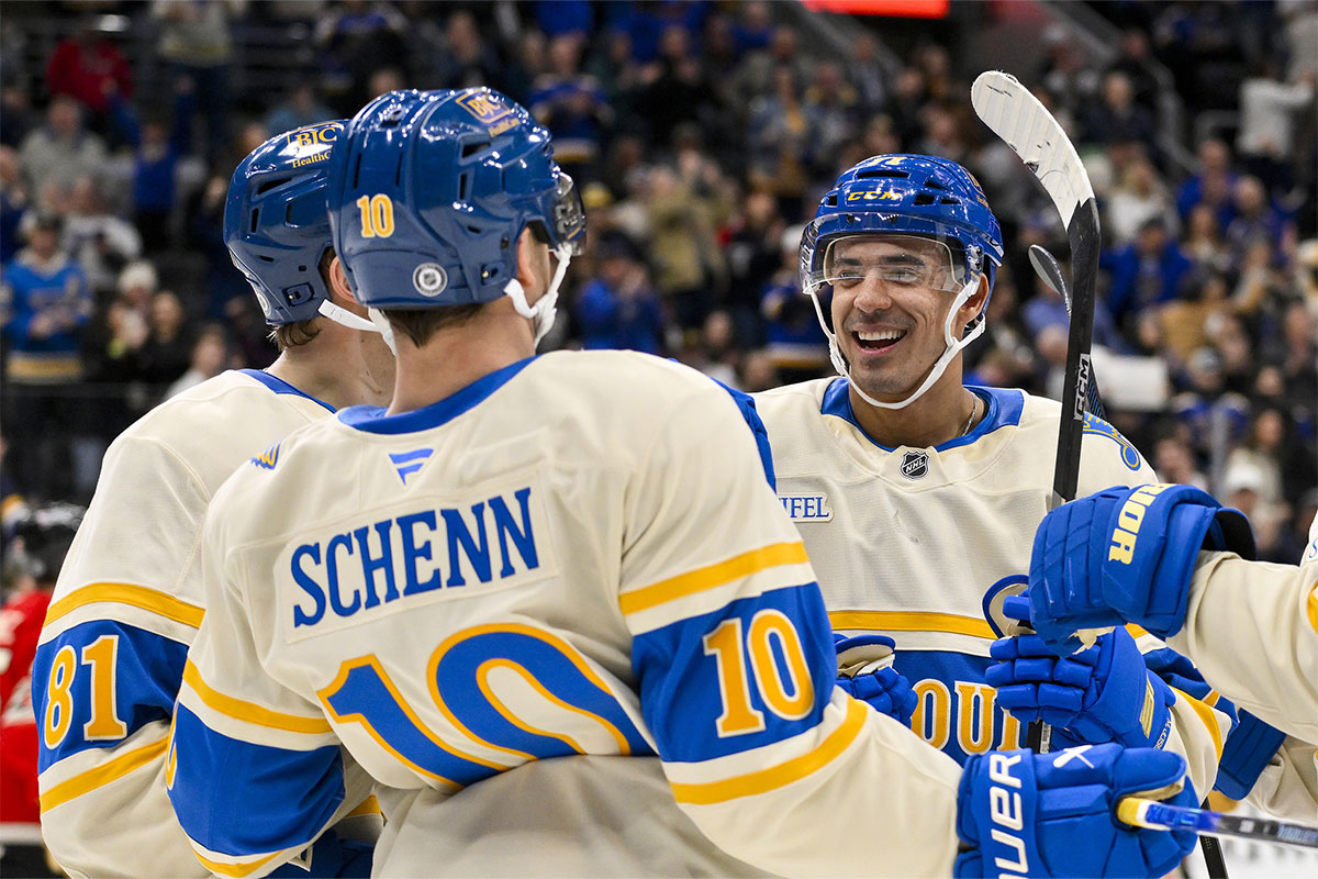 St. Louis Blues right wing Mathieu Joseph (71) celebrates with center Dylan Holloway (81) and center Brayden Schenn (10) after scoring against the Chicago Blackhawks during the second period at Enterprise Center.