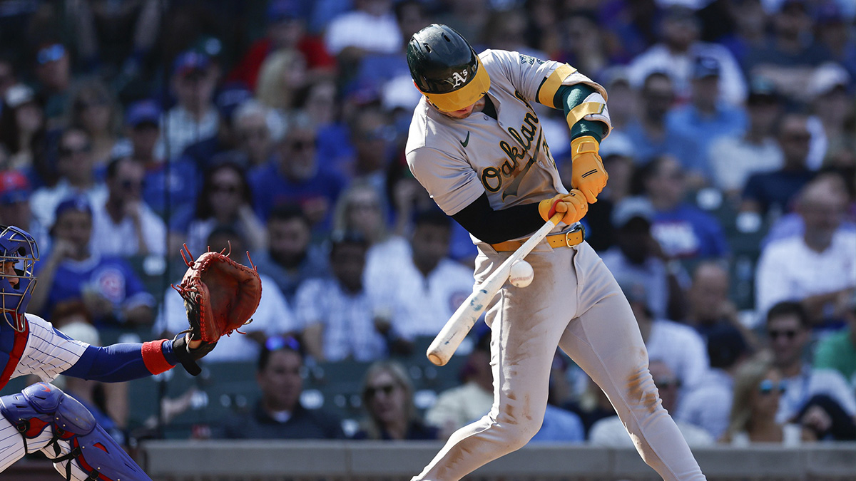 Oakland Athletics outfielder Brent Rooker (25) hits an RBI-single against the Chicago Cubs during the seventh inning at Wrigley Field. 