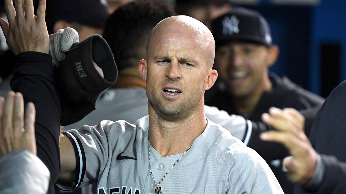 New York Yankees center fielder Brett Gardner (11) is greeted after hitting a solo home run against Toronto Blue Jays in the ninth inning at Rogers Centre.