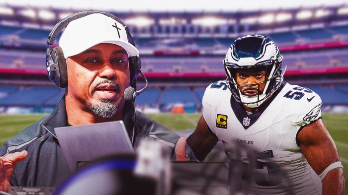 Brian Dawkins next to Brandon Graham on the Eagles field.