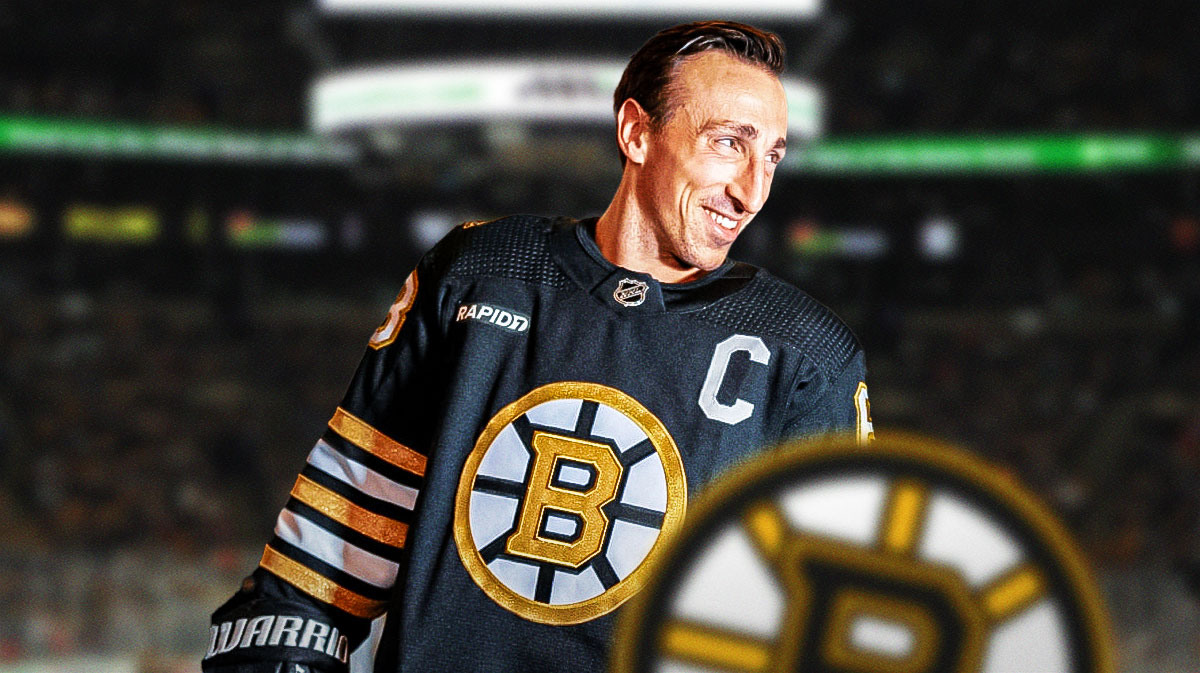 Photo: Brad Marchand smiling in Bruins jersey, TD Garden rink as background