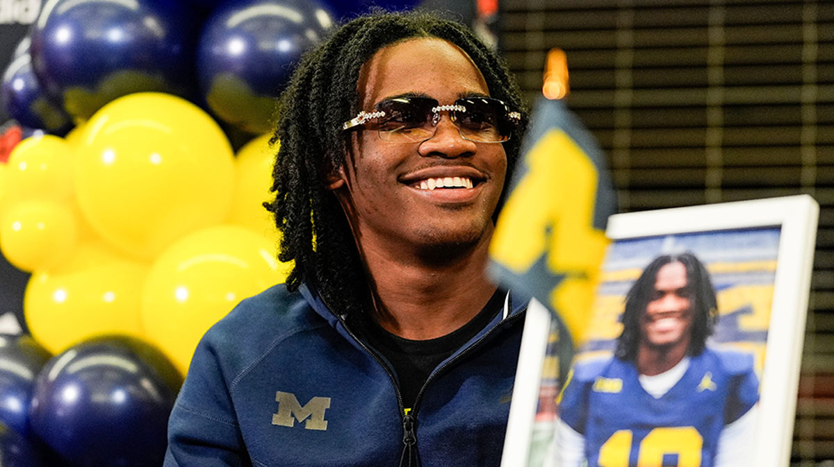 Michigan signee Bryce Underwood smiles during national signing day at Belleville High School