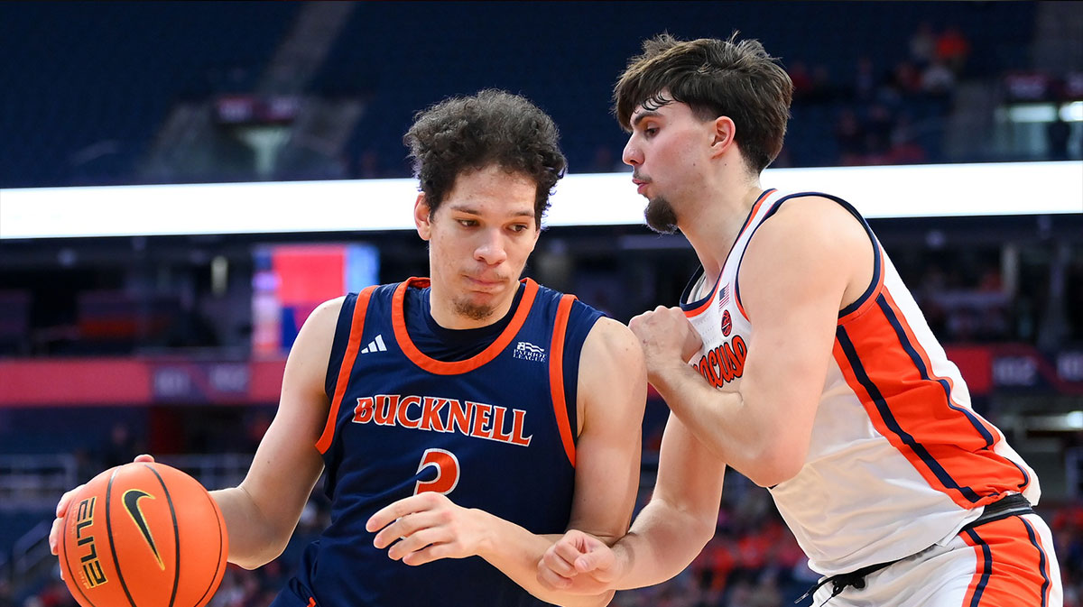 Dec 28, 2024; Bucknell Bison center Noah Williamson (3) drives against Syracuse Orange forward Petar Majstorovic (right) during the second half at the JMA Wireless Dome. Mandatory Credit: Rich Barnes-Imagn Images