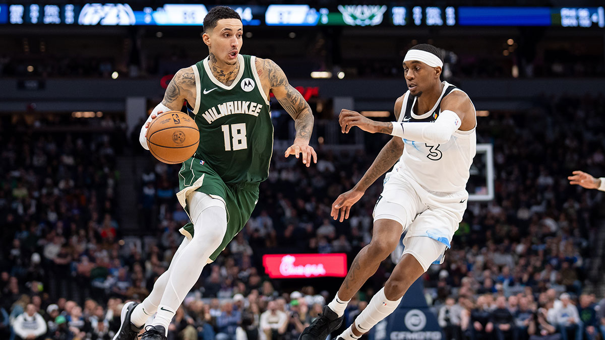 Milvaukee Bucks forward Kyle Kuzma (18) Dribbles v. Minnesote Timbervolves Next Jaden McDaniels (3) in the fourth quarter at the target center.