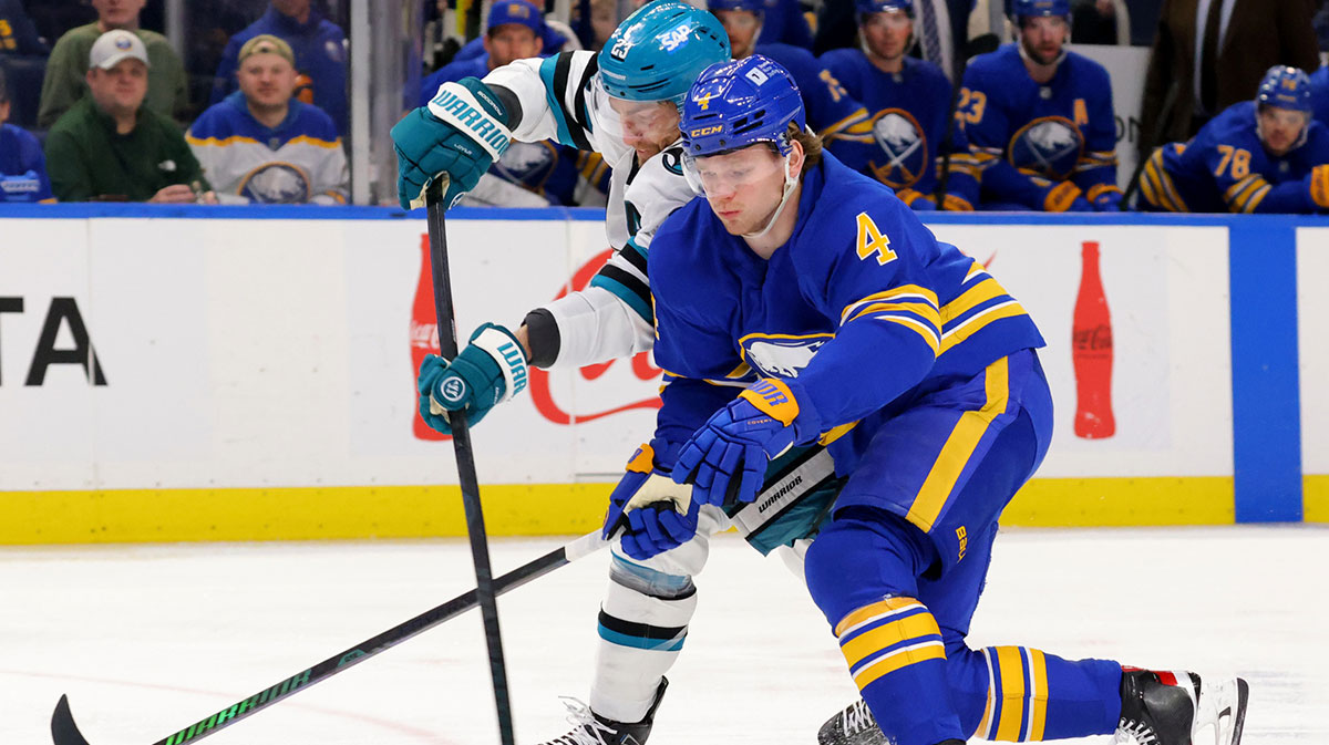 San Jose Sharks right wing Barclay Goodrow (23) tries to take a shot on goal as Buffalo Sabres defenseman Bowen Byram (4) defends during the first period at KeyBank Center. 