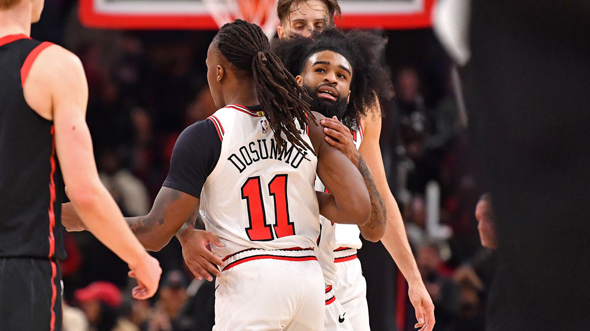 Chicago Bulls guard Coby White (behind) hugs guard Ayo Dosunmu (11) during overtime against the Toronto Raptors at the United Center.