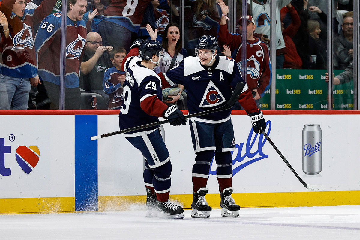 Colorado Avalanche defenseman Cale Makar (8) celebrates his game winning goal with center Nathan MacKinnon (29) in overtime against the Dallas Stars at Ball Arena