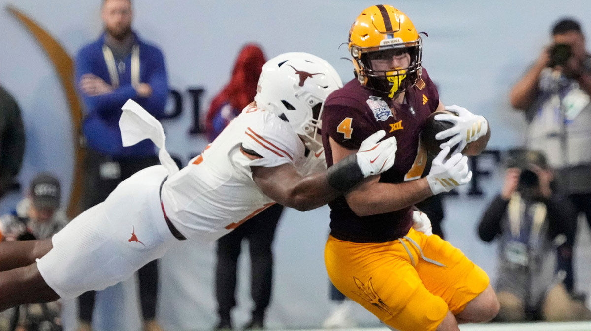 Arizona State running back Cam Skattebo (4) is tackled by Texas linebacker Colin Simmons (11) during the fourth quarter in the Chick-fil-A Peach Bowl in Atlanta on Wednesday, Jan. 1, 2025. 