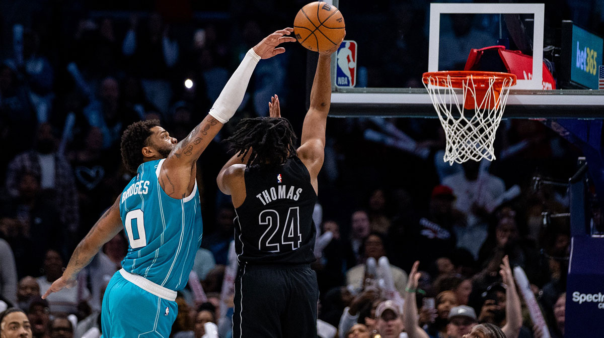 Charlotte Hornets forward Miles Bridges (0) blocks a shot from Brooklyn Nets guard Cam Thomas (24) during the fourth quarter at Spectrum Center.