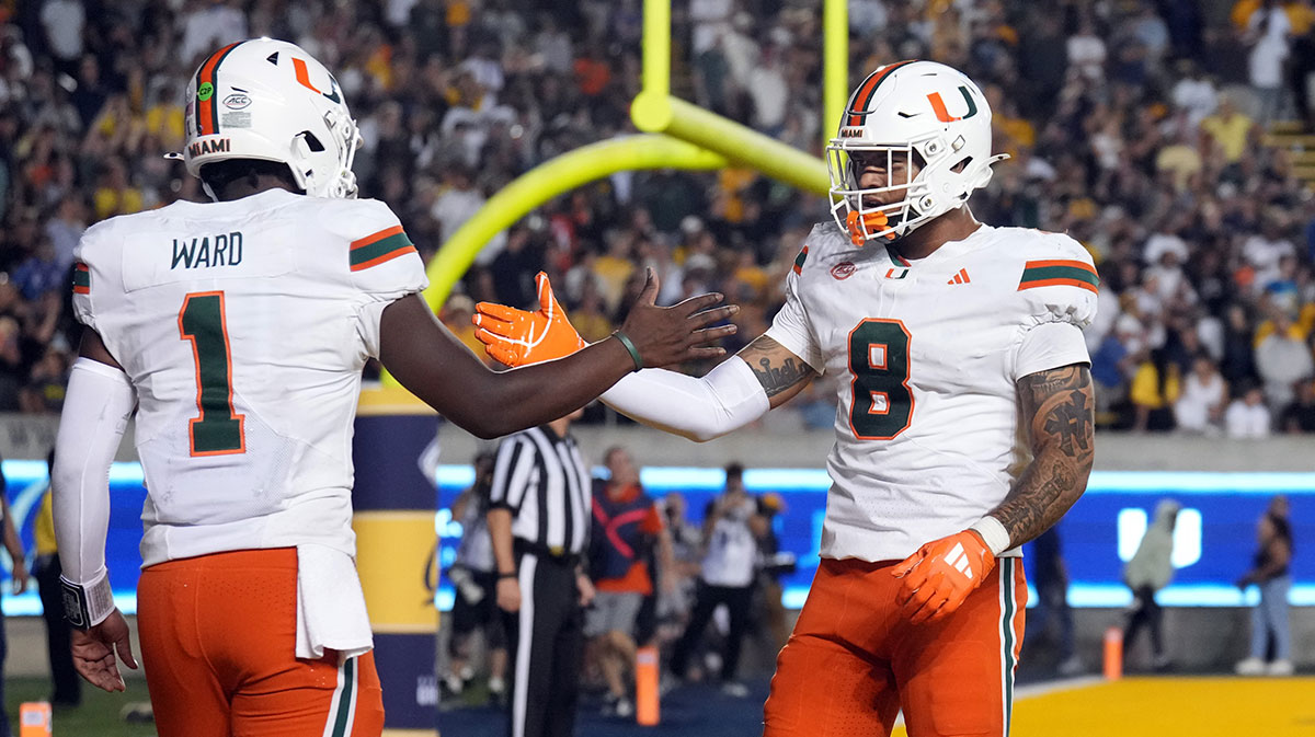 Miami Hurricanes quarterback Cam Ward (1) is congratulated by tight end Elijah Arroyo (8) after scoring a touchdown against the California Golden Bears during the fourth quarter at California Memorial Stadium. Mandatory Credit: Darren Yamashita-Imagn Images