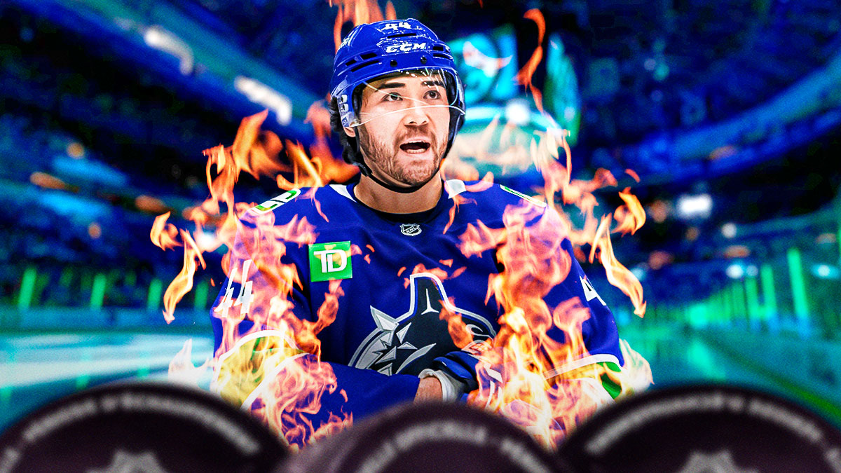 Kiefer Sherwood looking happy with fire around him, hockey rink in background