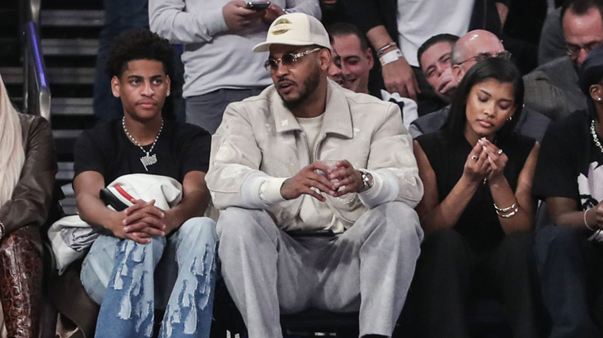 Former NBA player Carmelo Anthony (r) sits with his son Kiyan Anthony (l) at the game between the Boston Celtics and the New York Knicks at Madison Square Garden.