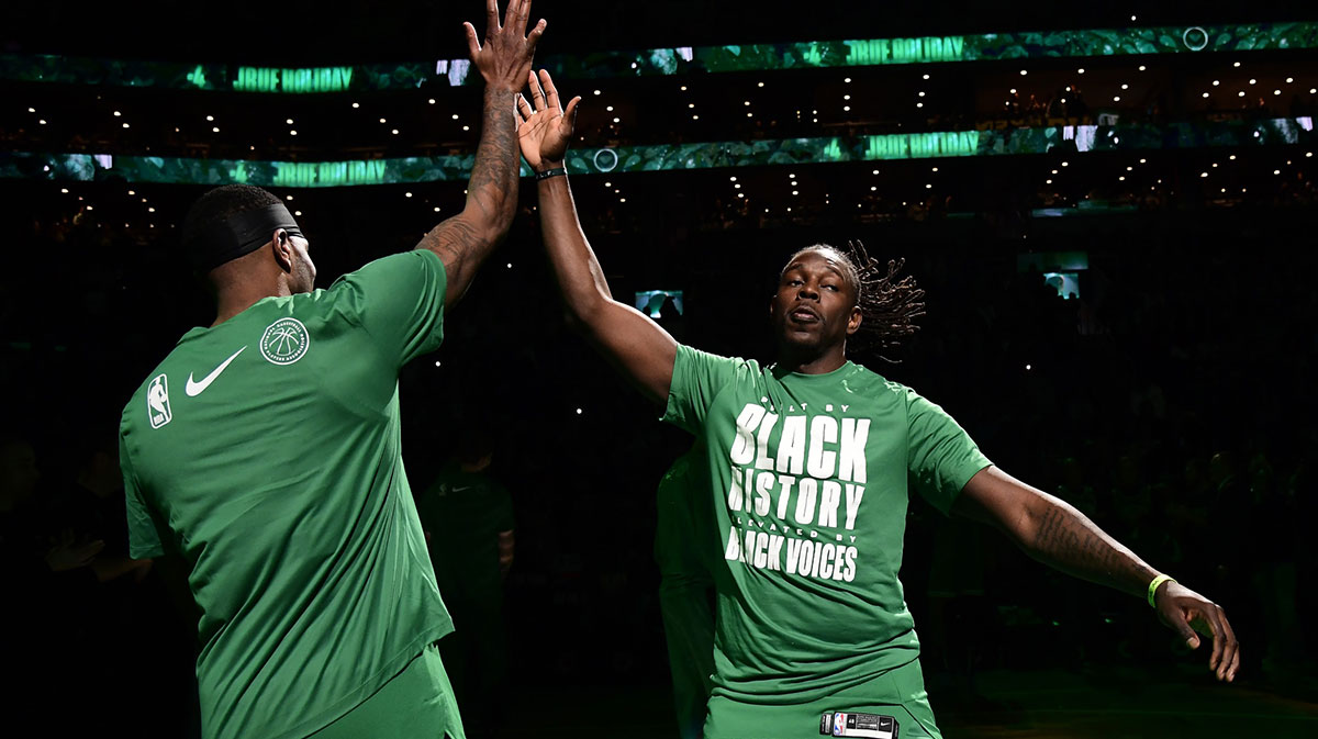 Celtics Guard Jue Holiday (4) High songs teammates after introduction before playing New York Kneaks on TD Garden