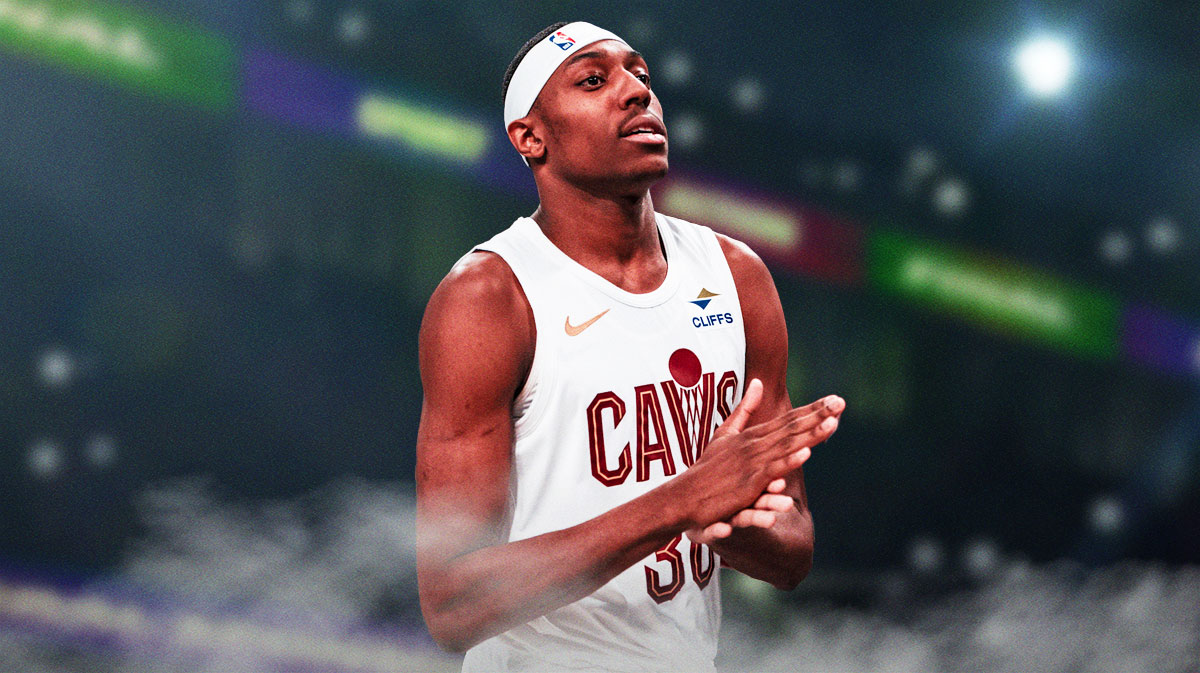 Nae'Qwan Tomlin looking happy, Cleveland Cavaliers jersey, basketball court in background