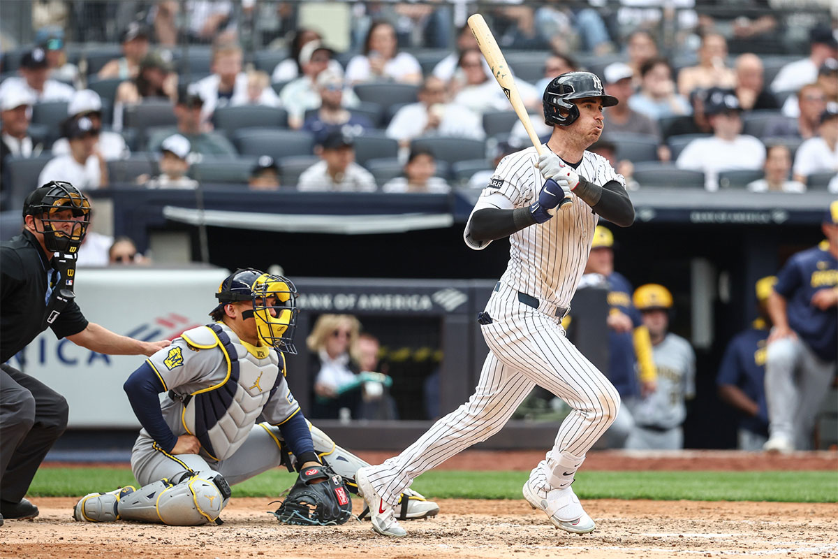New York Yankees left fielder Cody Bellinger (35) hits an RBI single in the sixth inning against the Milwaukee Brewers at Yankee Stadium.