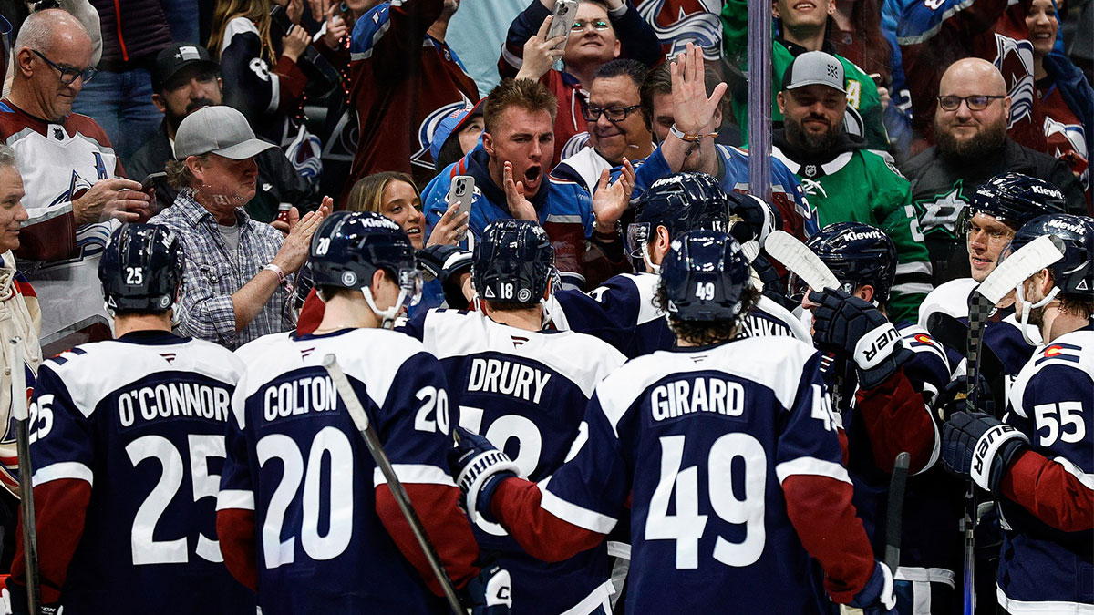 Colorado Avalanche players celebrate in front of Denver Broncos quarterback Bo Nix after the game against the Dallas Stars at Ball Arena.